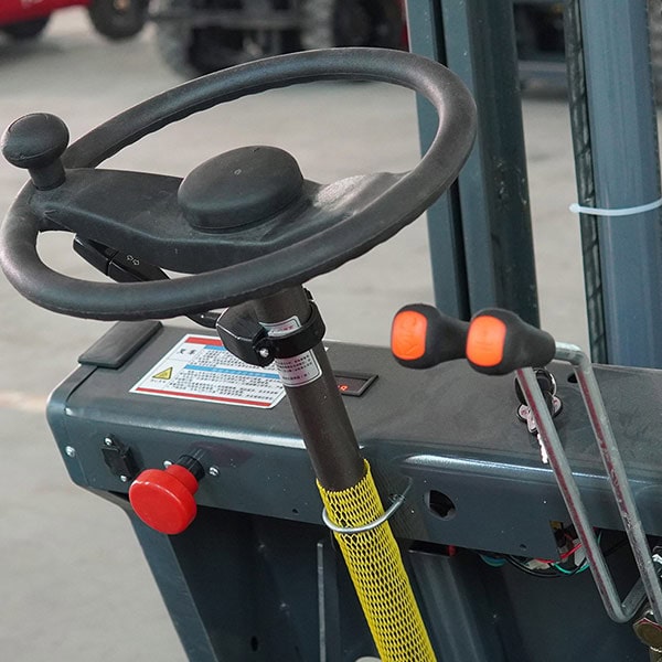 Close-up of forklift steering wheel and control levers for electric forklift operation.
