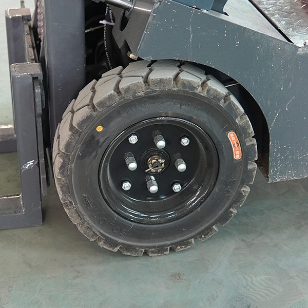 Close-up of Fangwei forklift wheel with rugged tire and black rim.